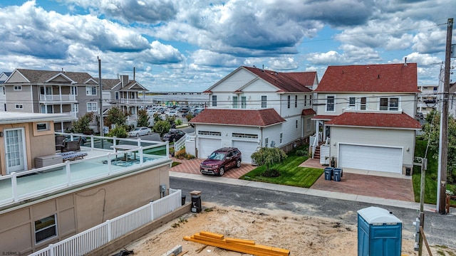 exterior space with a garage and a residential view