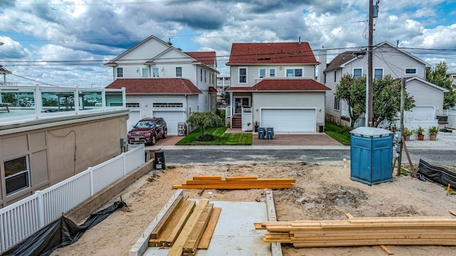 view of yard with a garage, a residential view, and fence