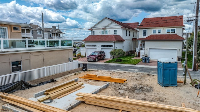 view of front of home featuring a garage and a residential view