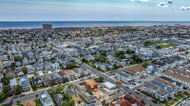 drone / aerial view with a water view and a residential view