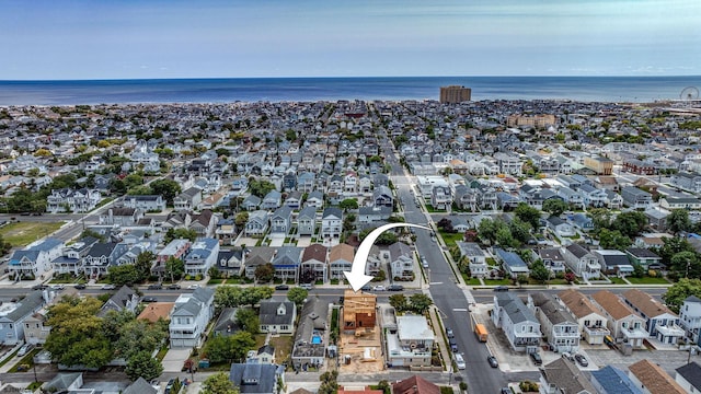 birds eye view of property with a water view and a residential view