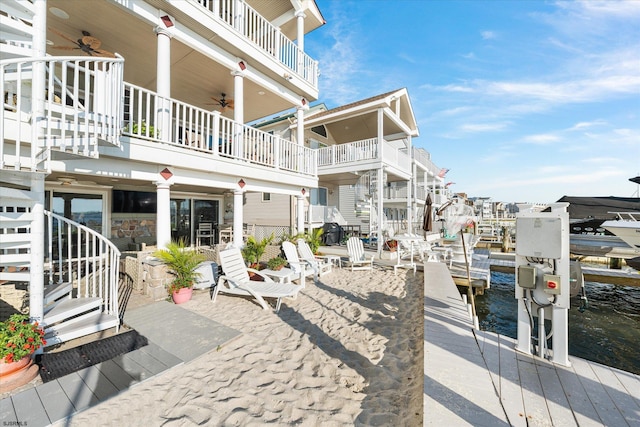 surrounding community with a water view and a dock