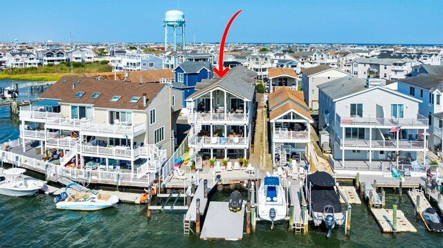 drone / aerial view featuring a residential view and a water view