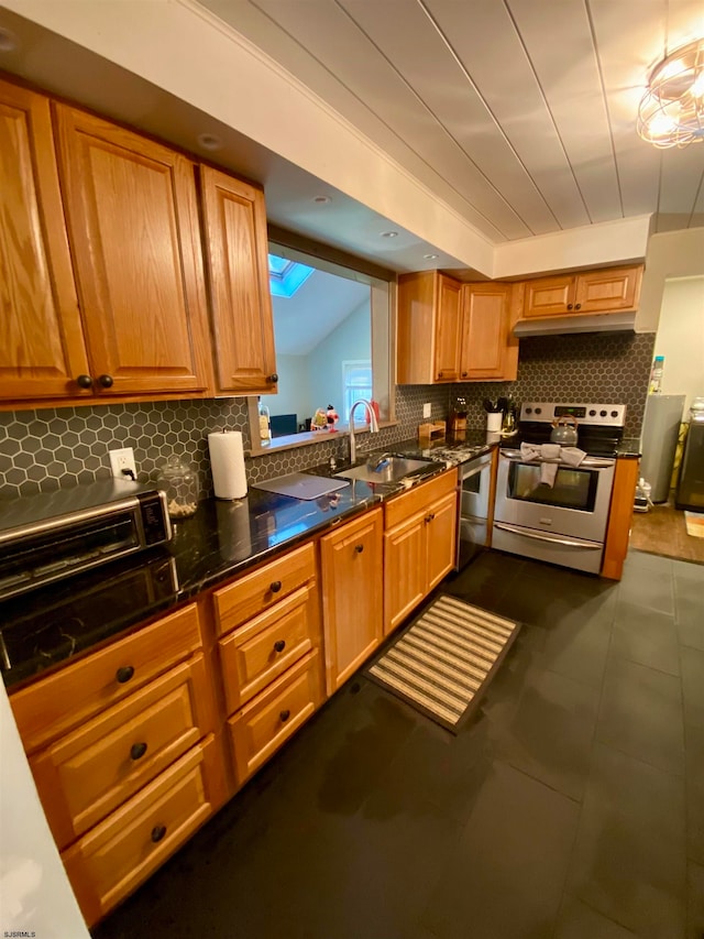 kitchen featuring tasteful backsplash, stainless steel electric range oven, dishwasher, sink, and dark tile patterned floors