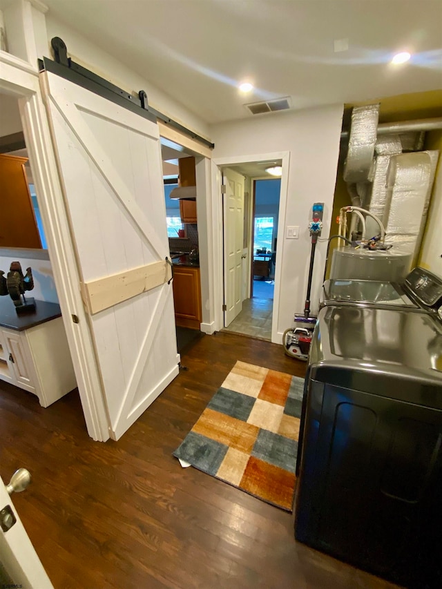 interior space with washing machine and dryer and hardwood / wood-style flooring