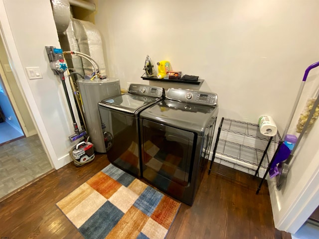 laundry room with washer and clothes dryer, water heater, and wood-type flooring