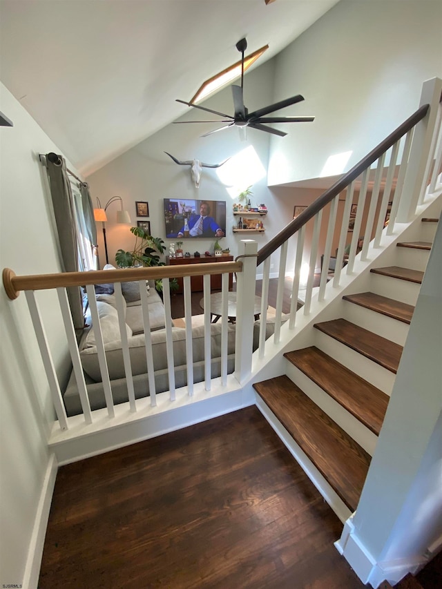 stairs featuring ceiling fan, lofted ceiling, and hardwood / wood-style floors