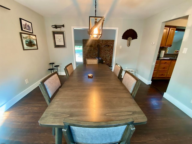 dining area featuring dark hardwood / wood-style flooring and a wood stove