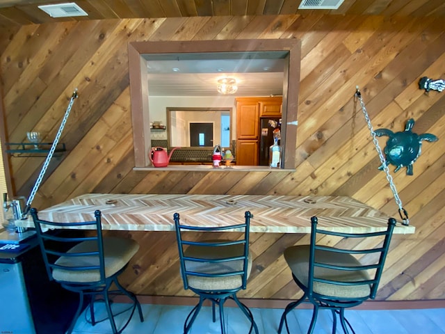 bar with refrigerator and wood ceiling