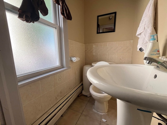 bathroom featuring a baseboard radiator, tile walls, toilet, and tile patterned floors