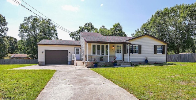 ranch-style home featuring a garage, a porch, and a front yard