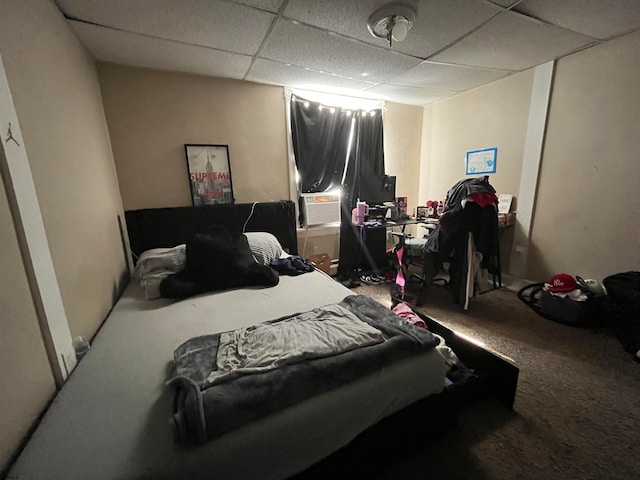 bedroom featuring a paneled ceiling and carpet