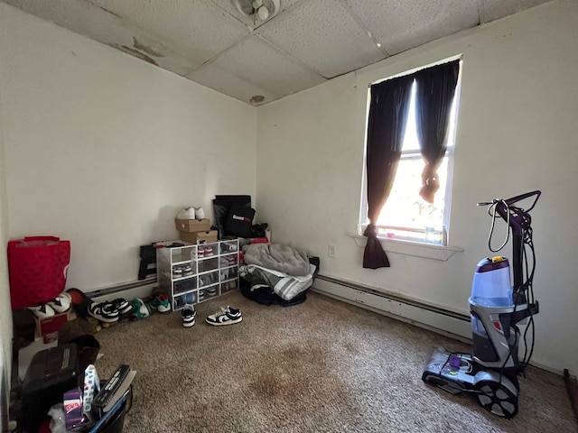 miscellaneous room with a paneled ceiling, baseboard heating, and carpet