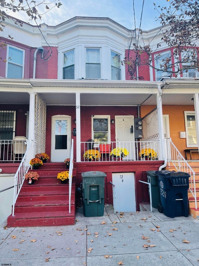 view of property featuring covered porch