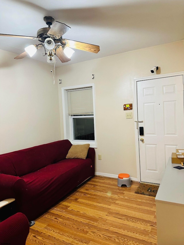 living room featuring light wood-type flooring and ceiling fan