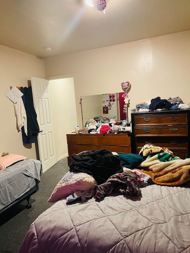 bedroom with dark colored carpet