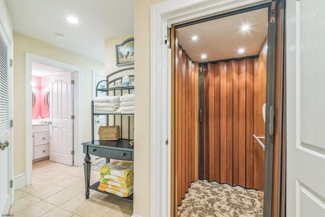 interior space with elevator and tile patterned flooring