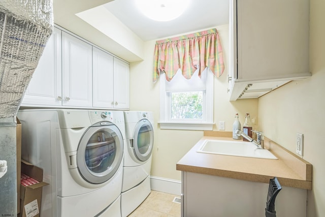 laundry area featuring light tile patterned floors, independent washer and dryer, cabinets, and sink