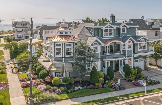 view of front of home featuring a balcony and a garage