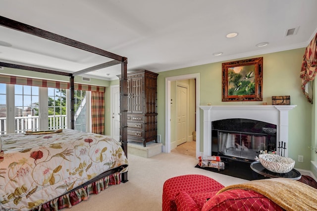 carpeted bedroom featuring crown molding and access to outside