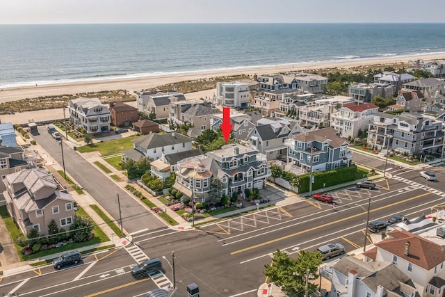 bird's eye view featuring a beach view and a water view