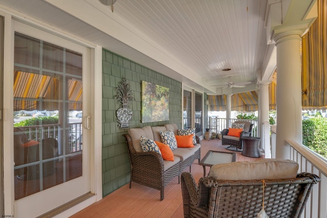 sunroom / solarium with ceiling fan and decorative columns