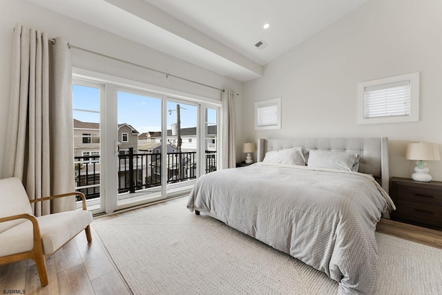 bedroom featuring vaulted ceiling, access to outside, and light hardwood / wood-style flooring