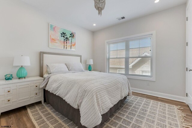 bedroom with wood-type flooring