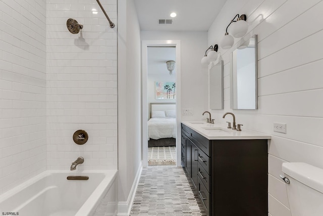 full bathroom featuring tiled shower / bath combo, vanity, toilet, and tile patterned flooring