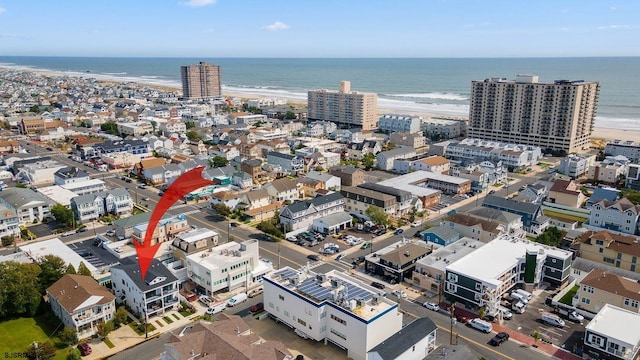 birds eye view of property featuring a view of the beach and a water view