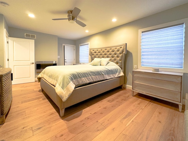 bedroom with ceiling fan and light hardwood / wood-style floors