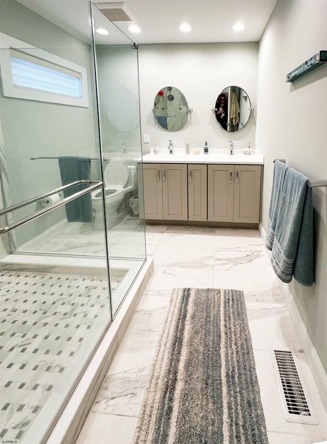 bathroom featuring toilet, double vanity, and tile patterned floors