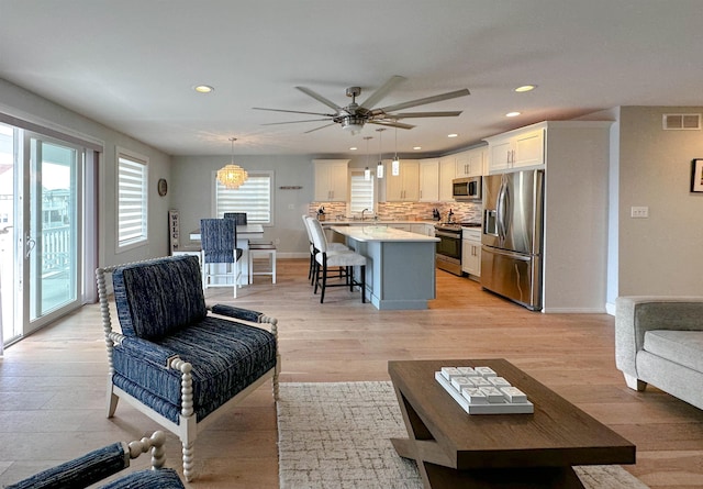 living room with a wealth of natural light and light hardwood / wood-style floors