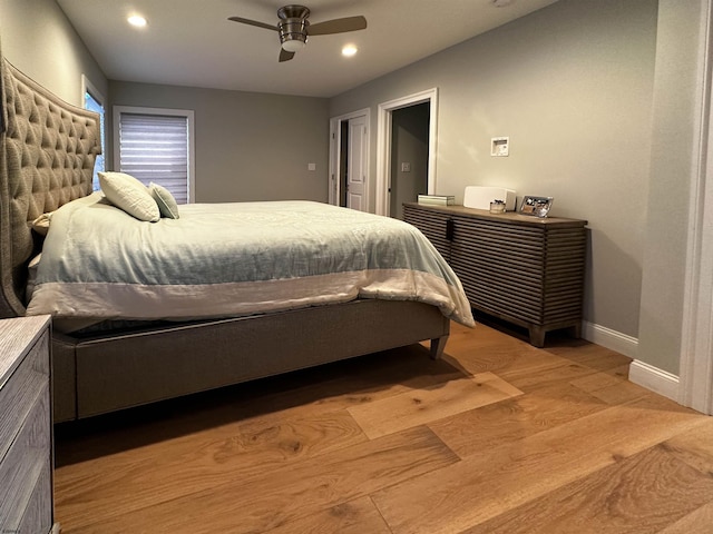 bedroom with light hardwood / wood-style flooring and ceiling fan