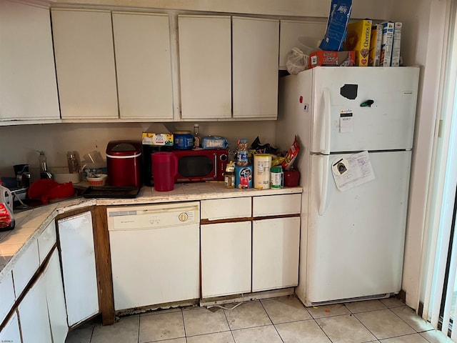 kitchen featuring white cabinetry, white appliances, tile countertops, and light tile patterned floors