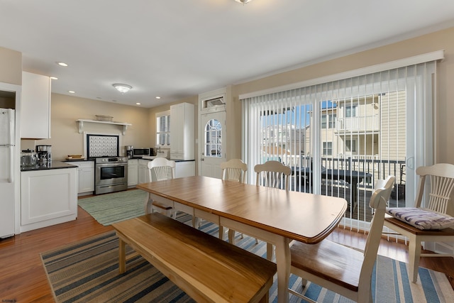 dining area featuring recessed lighting and wood finished floors