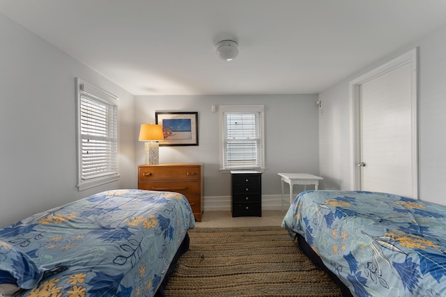 bedroom with tile patterned flooring and baseboards