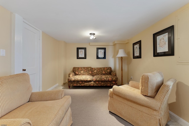 living room featuring carpet flooring and baseboards