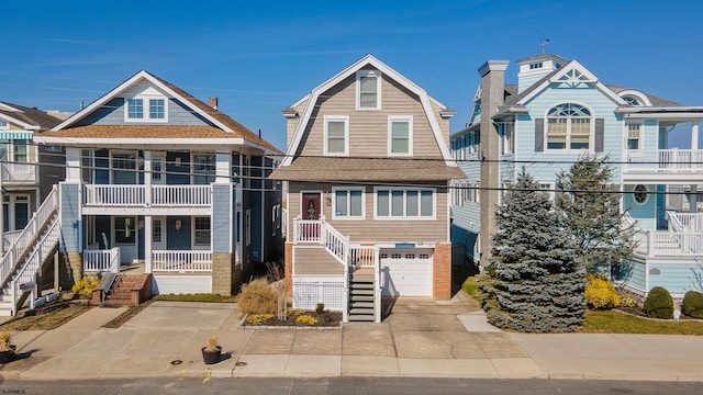 view of front of property featuring a balcony and a garage