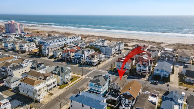 birds eye view of property featuring a water view and a view of the beach