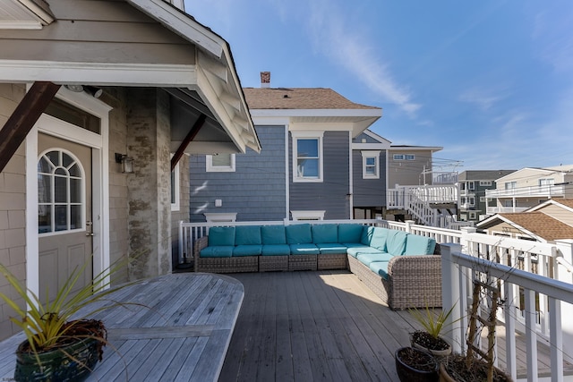 wooden terrace featuring a residential view and an outdoor living space