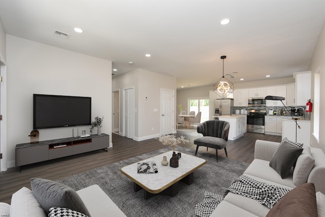 living room with dark wood-type flooring and sink