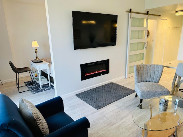 living room featuring light wood-type flooring and a barn door