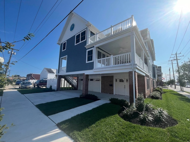 view of front facade with a front lawn, a garage, and a balcony