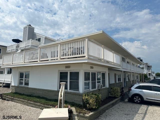 view of side of property with a balcony