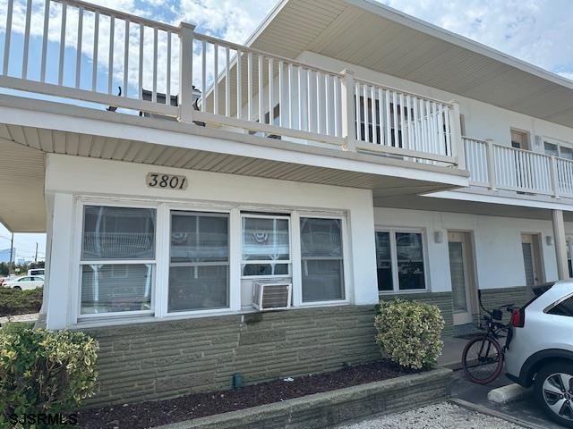 view of side of home featuring a balcony