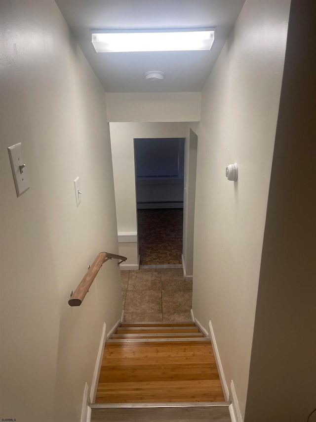 stairway with hardwood / wood-style flooring