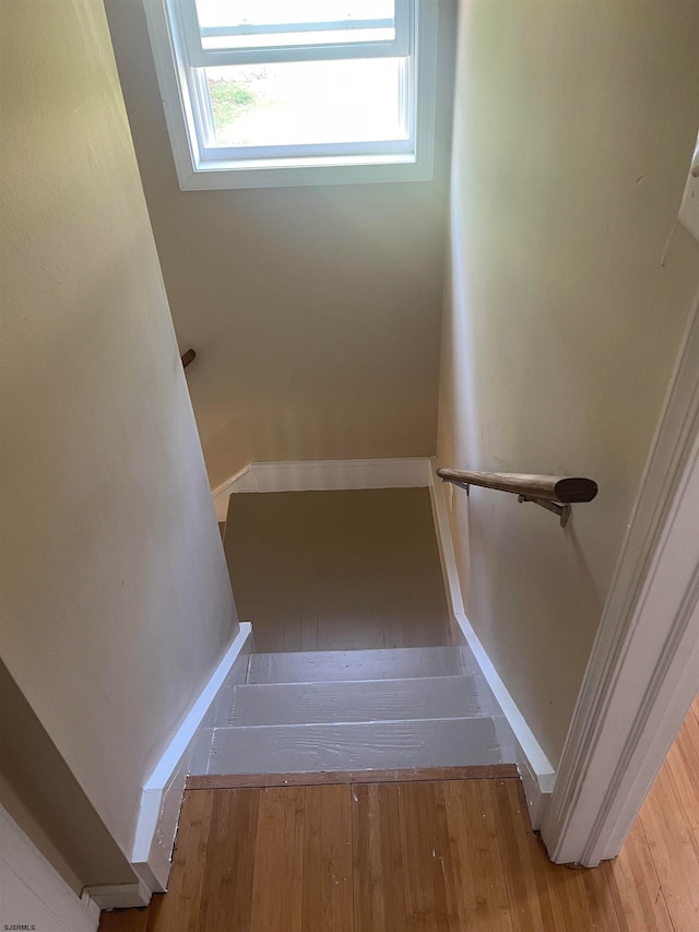 staircase featuring hardwood / wood-style flooring