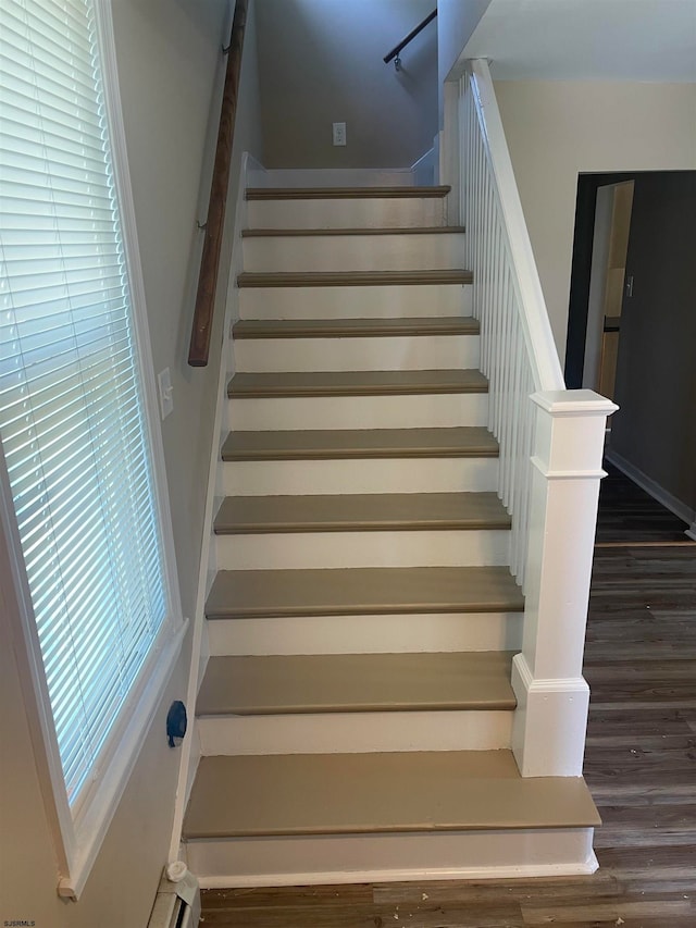 stairs featuring hardwood / wood-style flooring