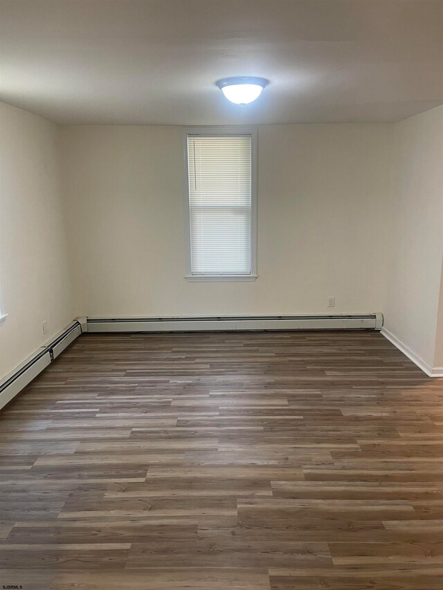 empty room featuring dark wood-type flooring